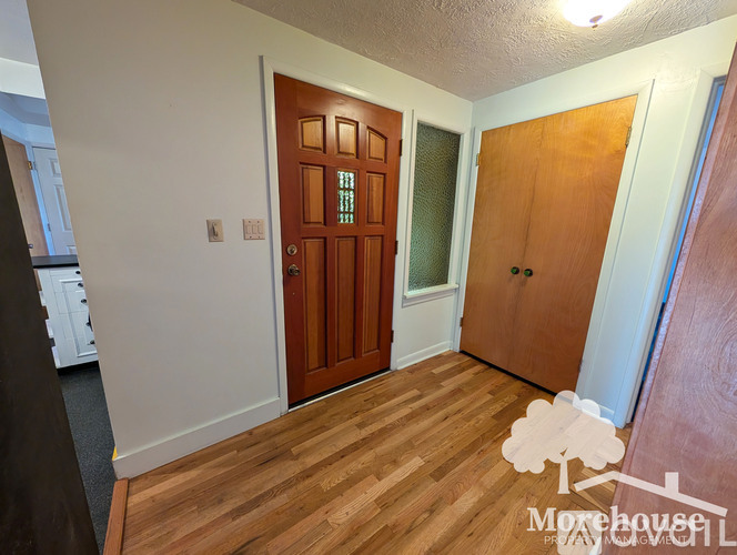 A room with a brown door and a white door.