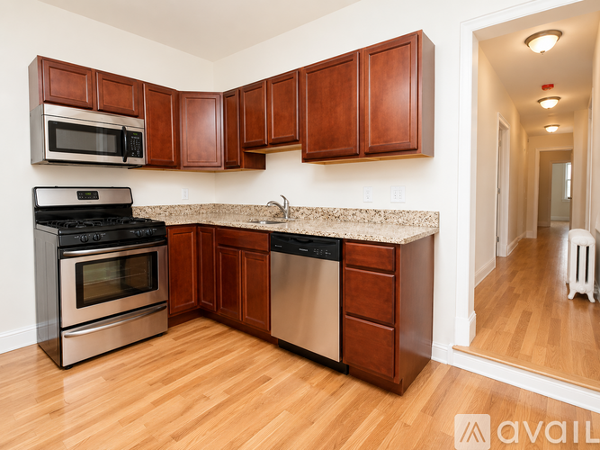 A kitchen with wooden cabinets and a granite countertop.