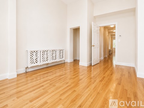 A room with wooden floors and white walls.