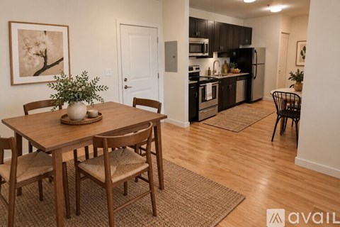 A kitchen with a dining table and chairs.