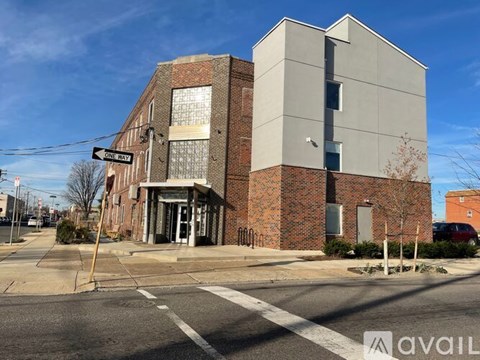 A street view of a building with a sign that says One Way.
