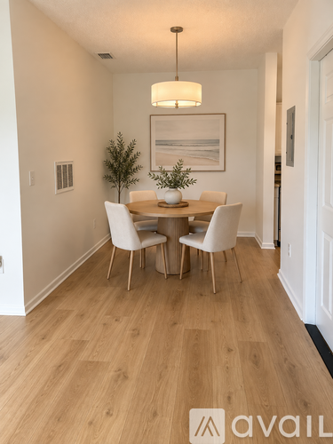 A dining room with a wooden table and chairs.