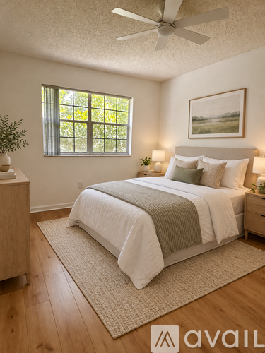 A bedroom with a bed, nightstand, and window.