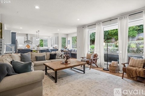 A living room with a couch, chairs, and a coffee table.