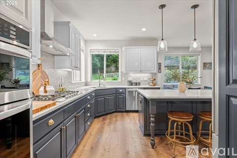 A kitchen with a white stove top oven and a white microwave above it.