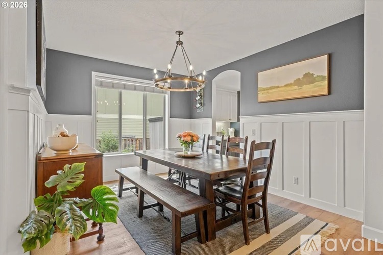 A dining room with a wooden table and chairs.