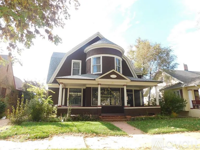 A house with a porch and a covered front door.