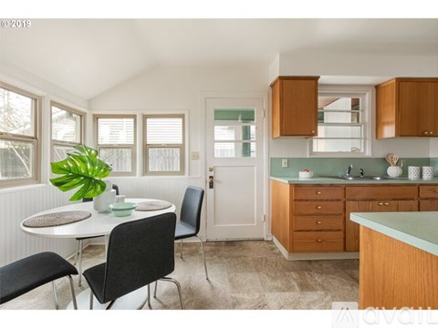 A kitchen with a table and chairs in the middle of the room.