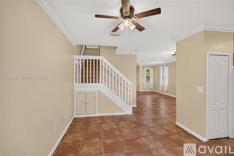 A living room with a staircase leading to the upper floor.