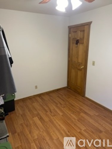 A room with a wooden floor and a wooden door.