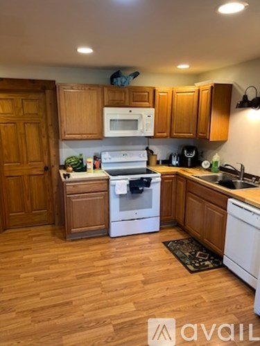 A kitchen with wooden cabinets and a white oven.