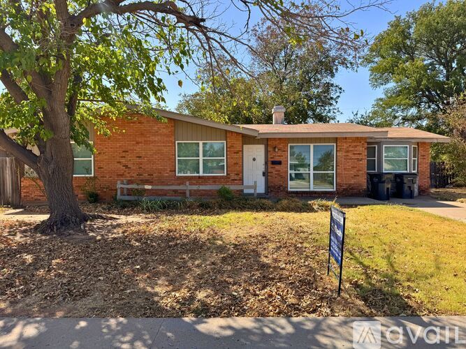 A house with a tree in front of it.