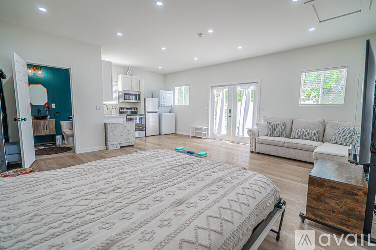 A bedroom with a large bed and a couch.
