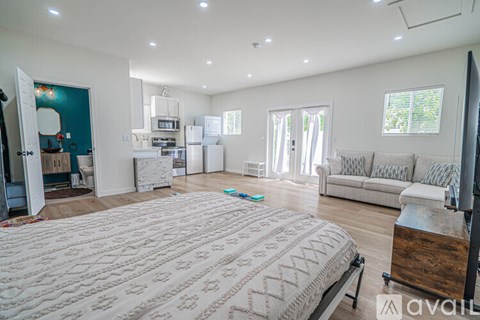 A bedroom with a large bed and a couch.