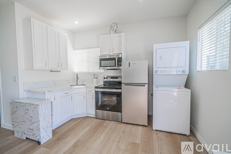 A kitchen with white cabinets and stainless steel appliances.