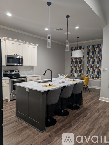 A kitchen with a large island and modern appliances.