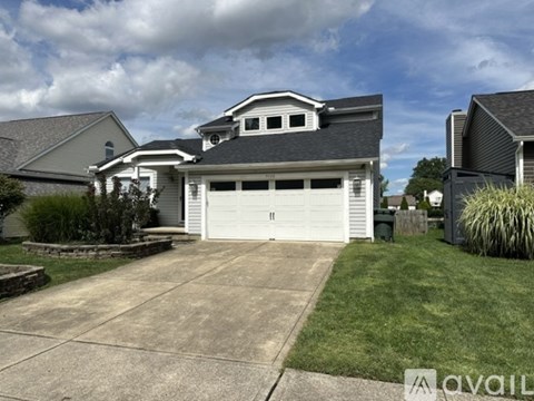 A two-story house with a garage is for sale.