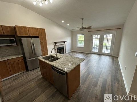 A kitchen with wooden cabinets and a granite countertop.