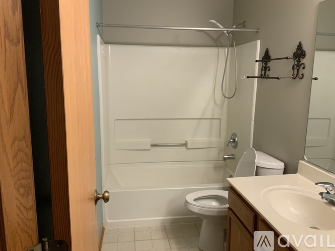 A bathroom with a toilet, sink, and bathtub.