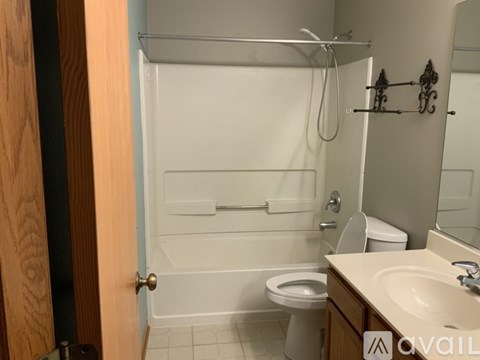 A bathroom with a toilet, sink, and bathtub.