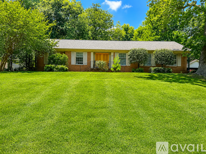 A house with a lawn in front of it.