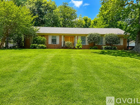 A house with a lawn in front of it.