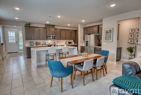 A modern kitchen with a dining table and chairs.