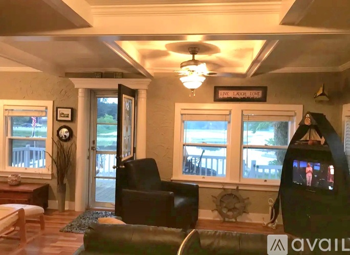 A living room with a couch, chair, and a television.
