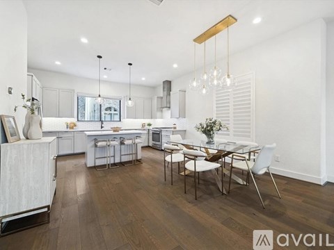 A modern kitchen with a dining table and chairs.