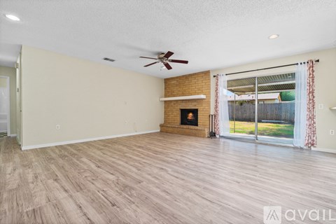 A room with a fireplace and sliding glass doors.