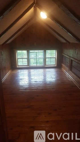 A room with wooden floors and a window.