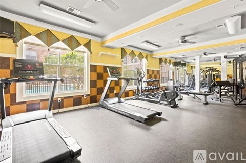 A gym with treadmills, weights, and exercise equipment.