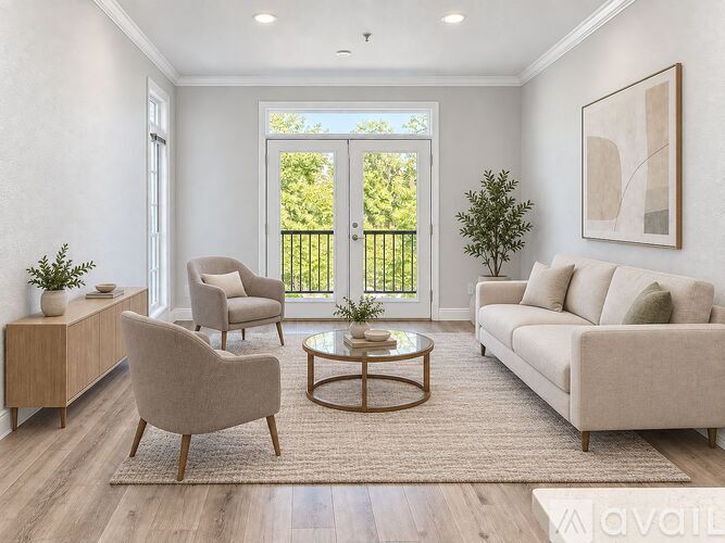 A living room with a sofa, two chairs, a coffee table, and a plant.