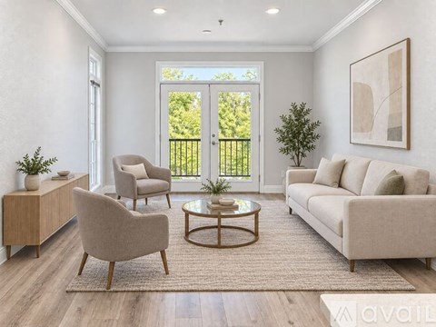 A living room with a sofa, two chairs, a coffee table, and a plant.