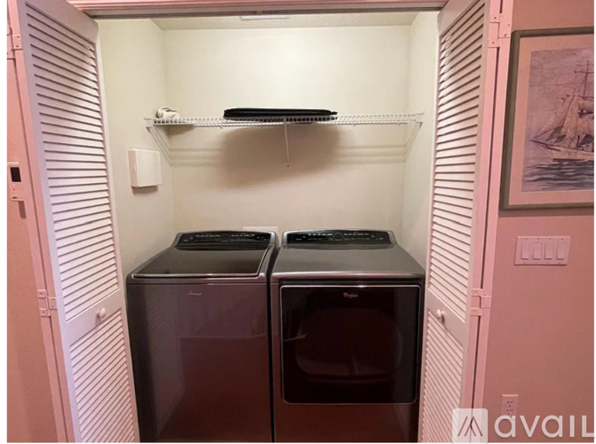 A small laundry room with two front loading washing machines.