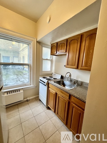 A kitchen with wooden cabinets and a white stove top oven.