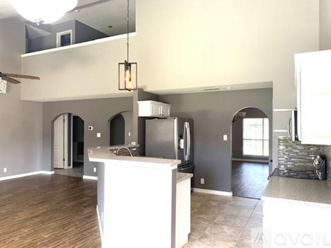 A kitchen with a white counter and a refrigerator.