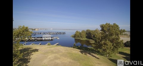 A large body of water with a dock and boats.