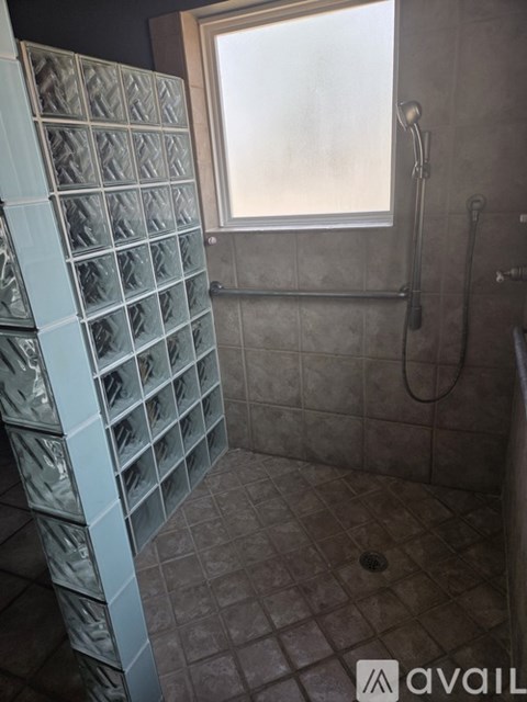 A bathroom with a window and a shower.