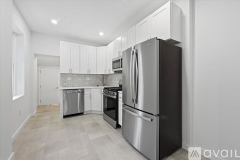 A kitchen with a black refrigerator, stove, and oven.