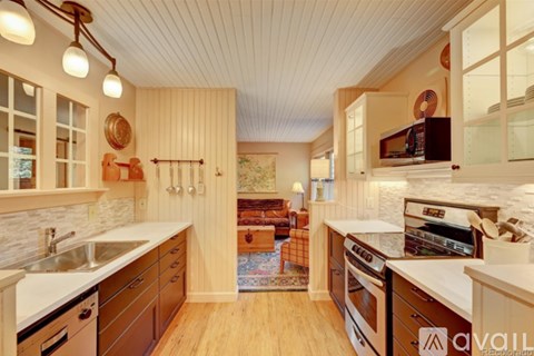 A kitchen with wooden cabinets and a white countertop.