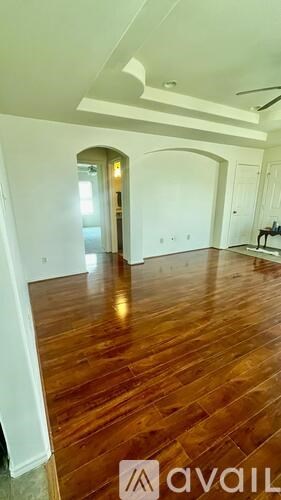 A room with wooden floors and white walls.