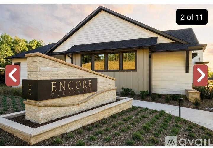 A sign that says Encore Clubhouse in front of a building.