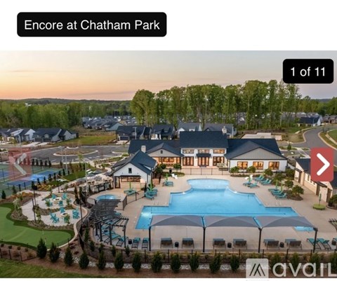 A large building with a pool in front of it at Chatham Park.