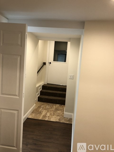 A hallway with a staircase leading to a second floor.