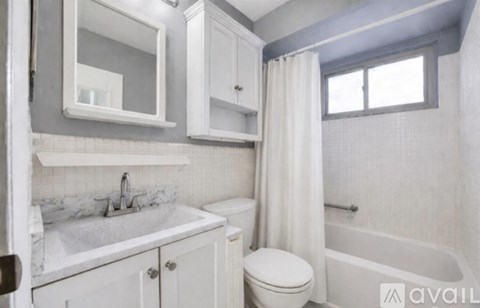A white bathroom with a sink, toilet, and bathtub.