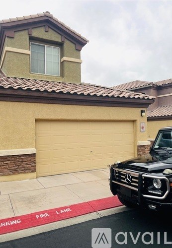 A black Mercedes-Benz G-Class SUV is parked in front of a garage.