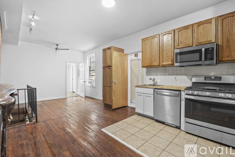 A kitchen with wooden cabinets and stainless steel appliances.