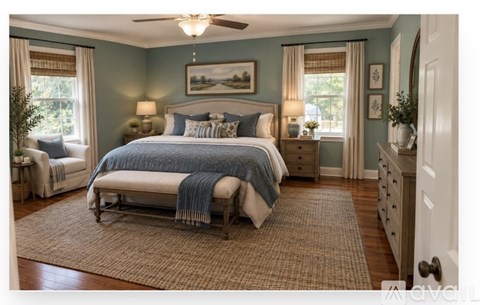 A bedroom with a bed, a bench, and a rug.