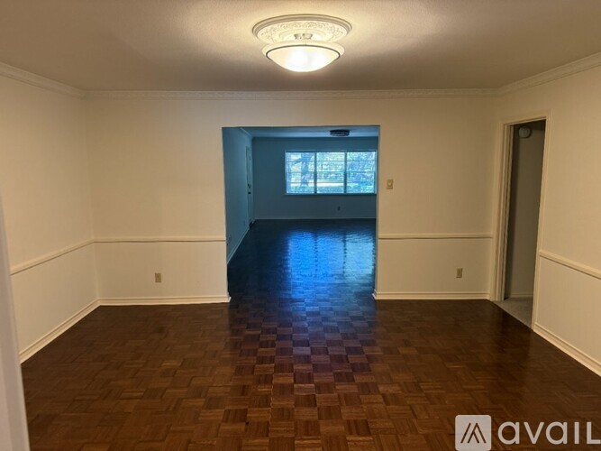 A room with a checkered floor and a window.
